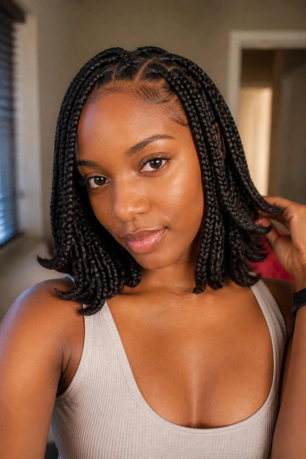 Shoulder-length knotless braids with flipped ends on a real person.