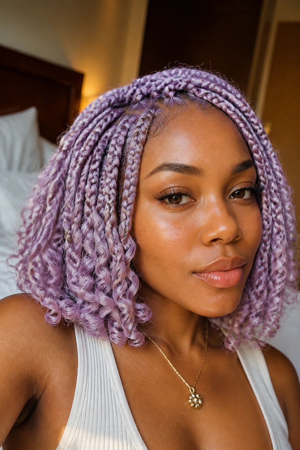 Close-up of a real woman with pastel lavender goddess curls in a bob.
