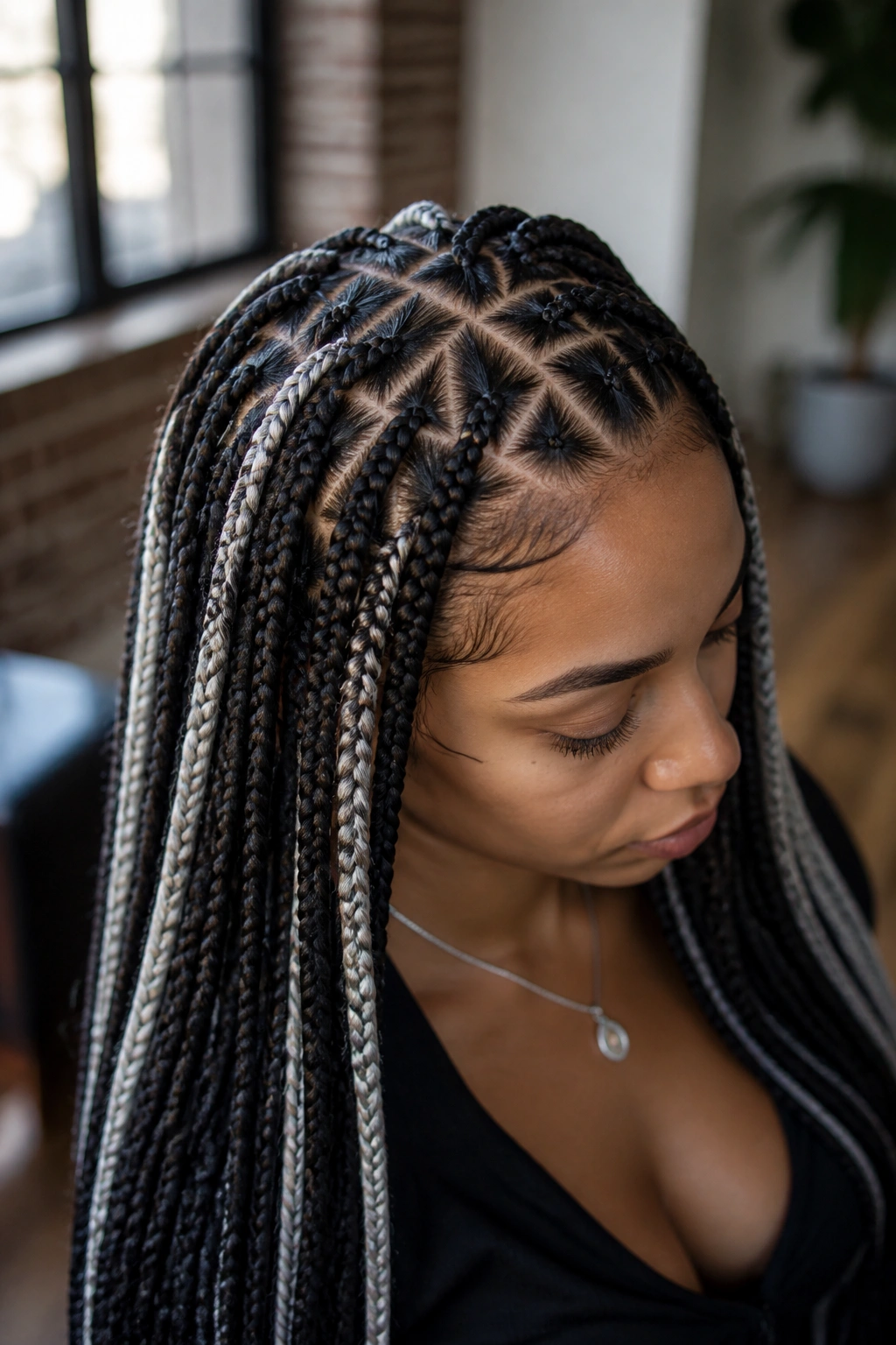 Close-up of dark-base knotless braids with platinum accents at the hairline.